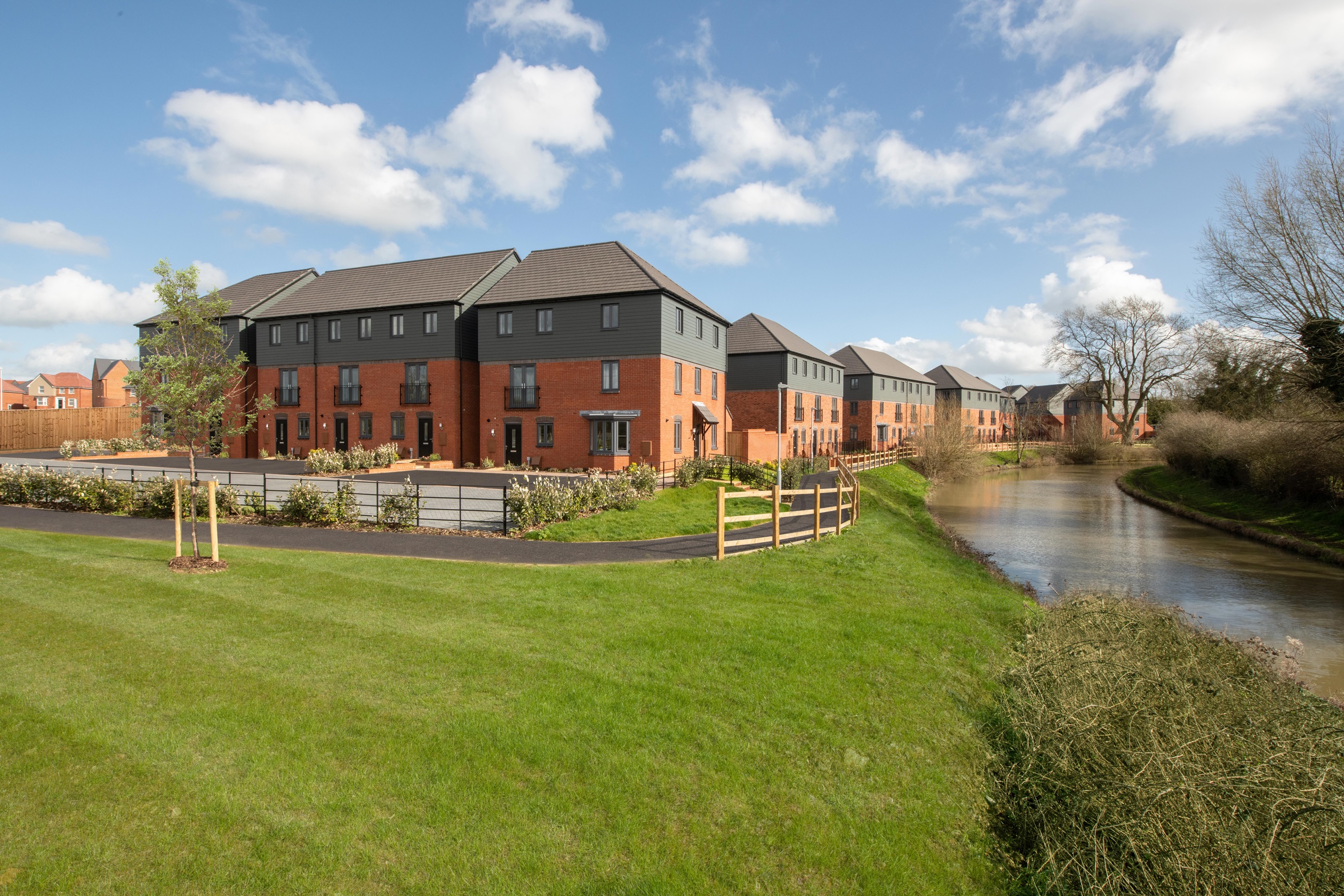External view of three bedroom homes by the canalside