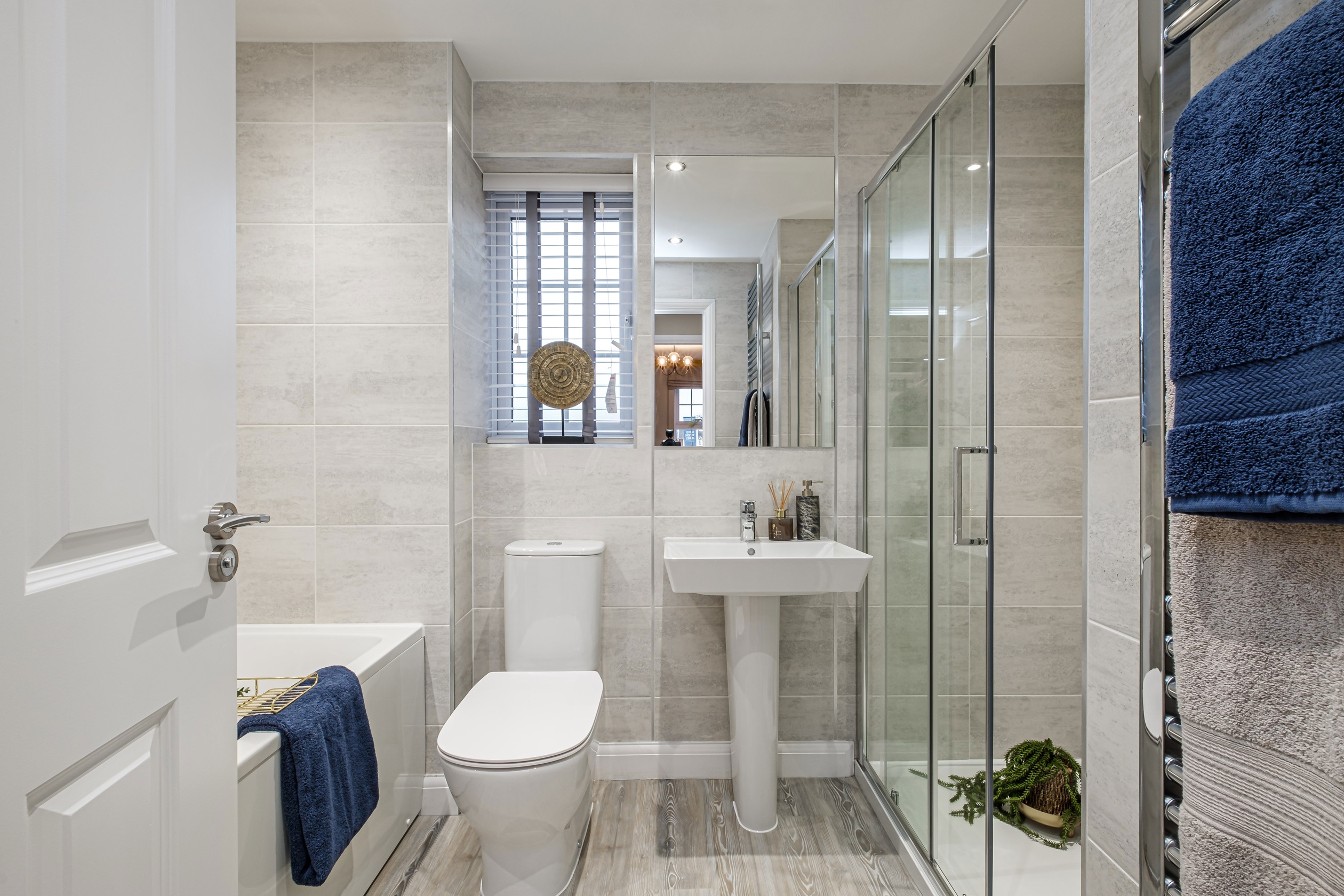Grey tiled bathroom with separate shower