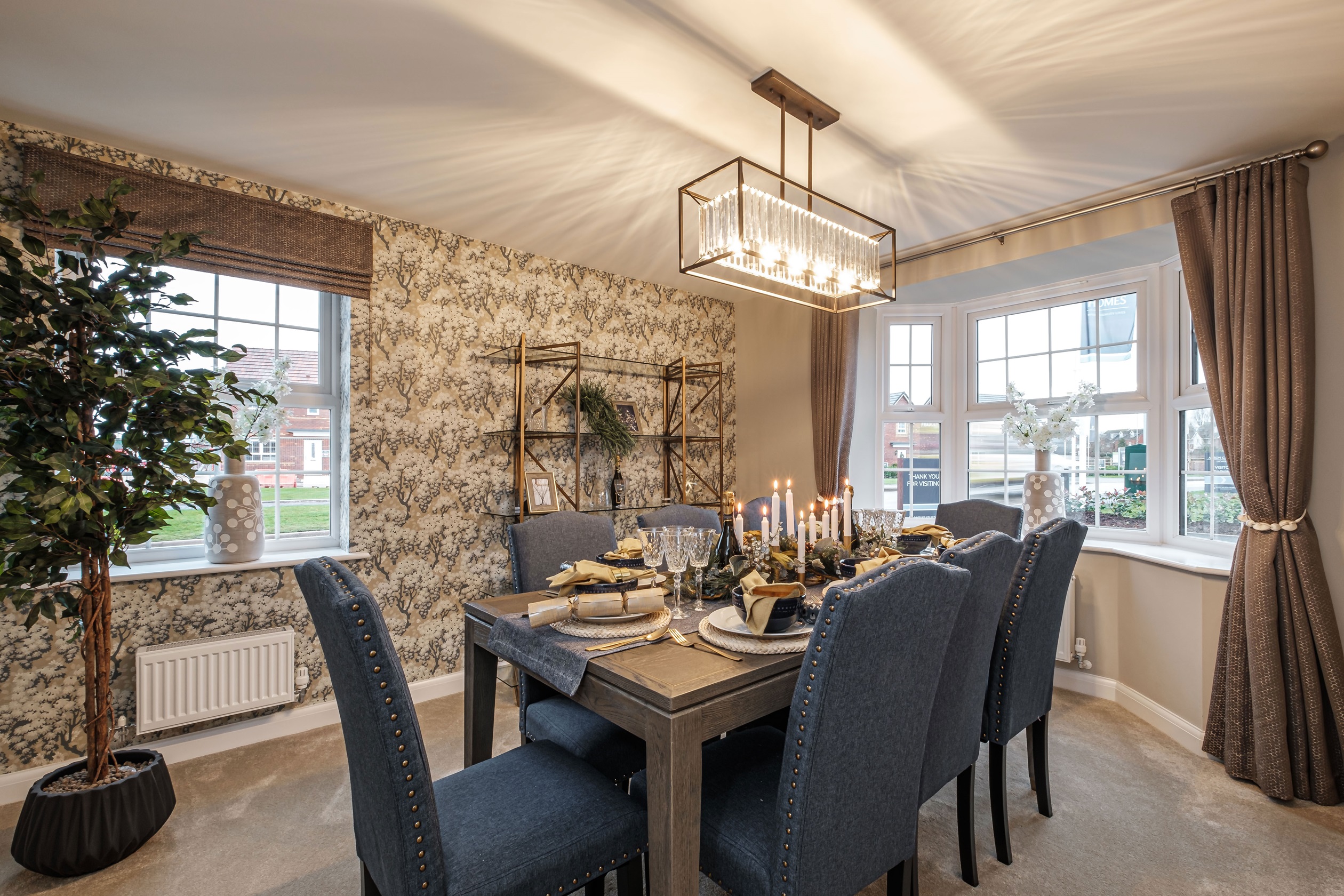 Dual-aspect dining room with bay window and blue chairs