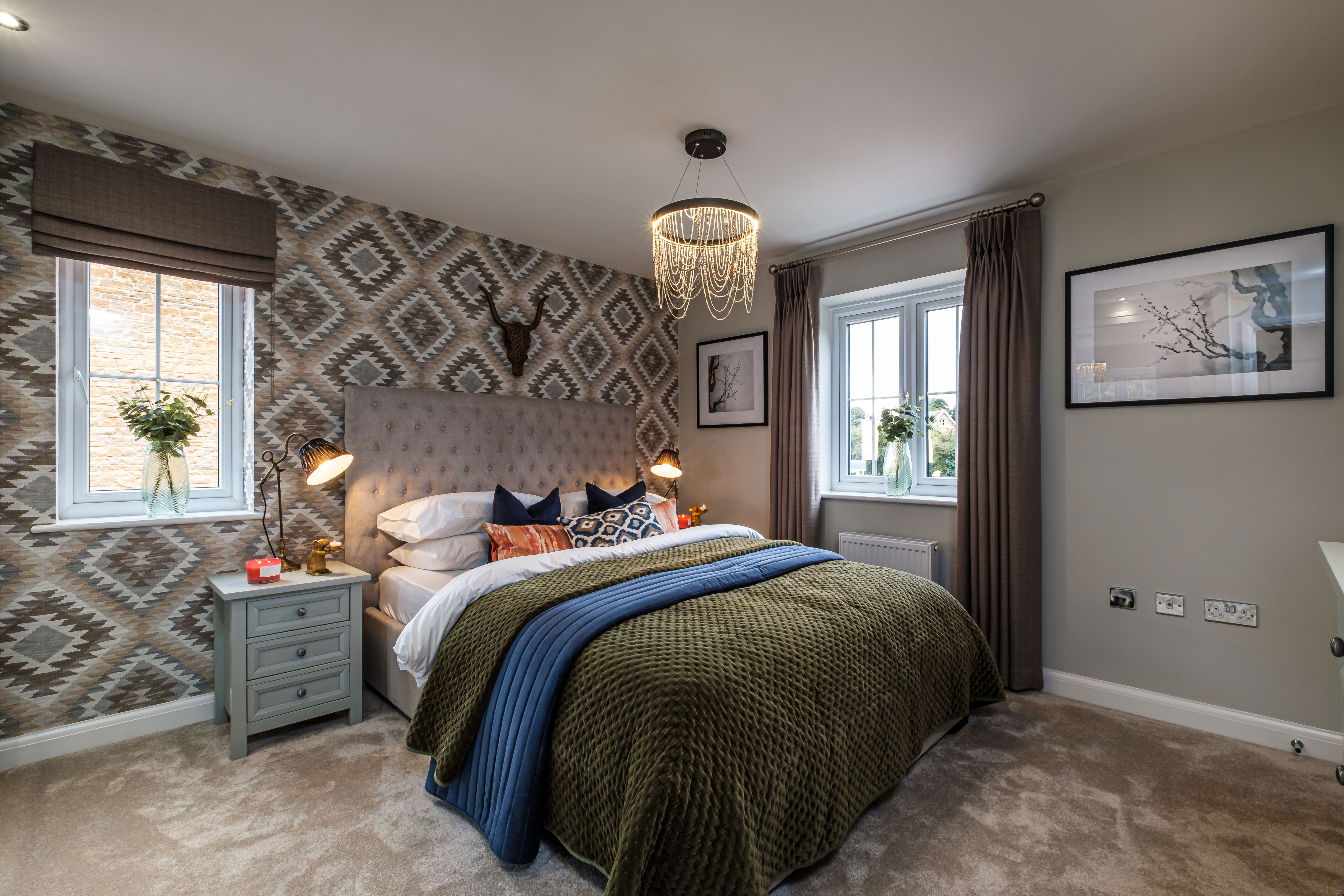 A dual aspect double bedroom with patterned wallpaper