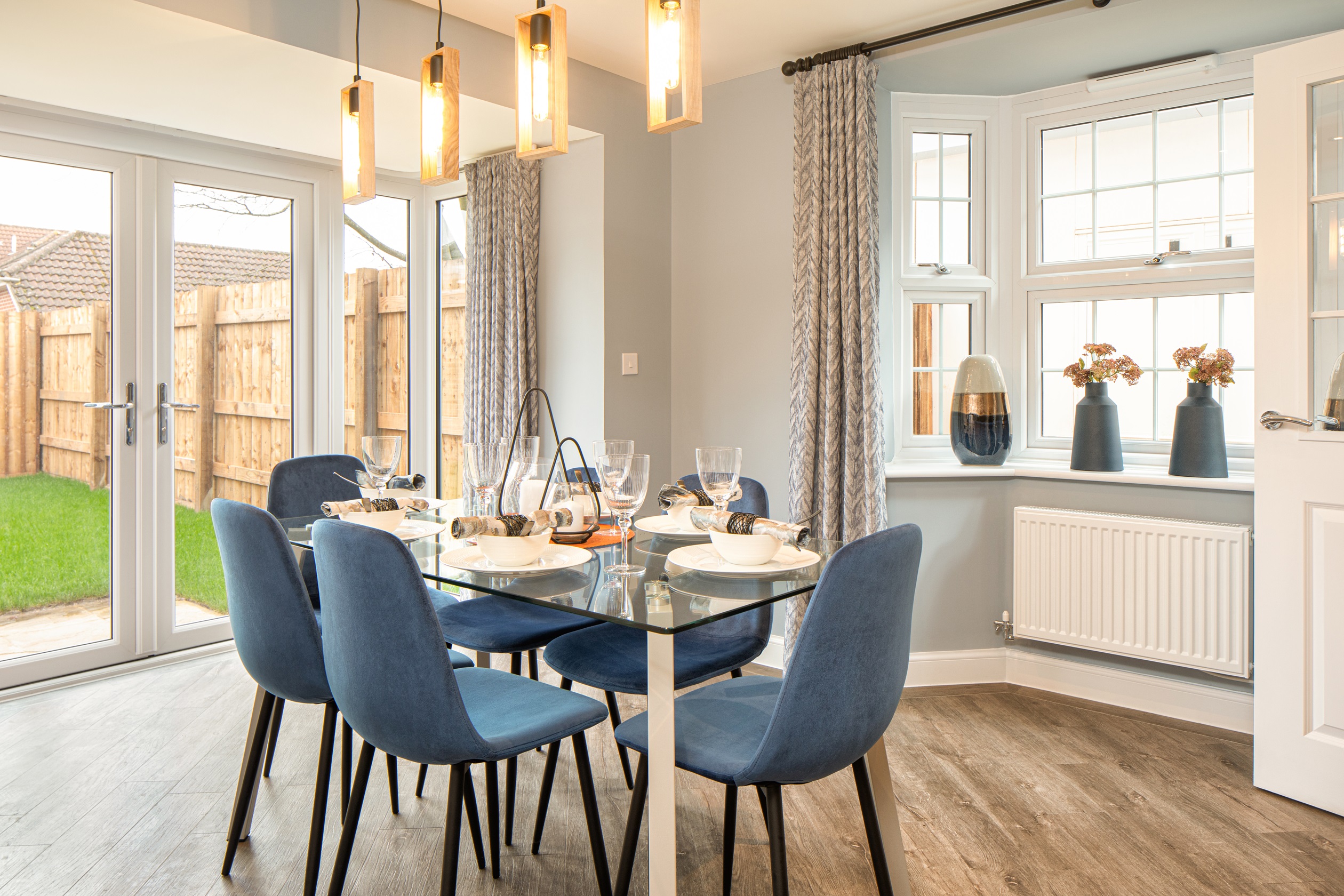 Dining area with bay window, French doors and dining table