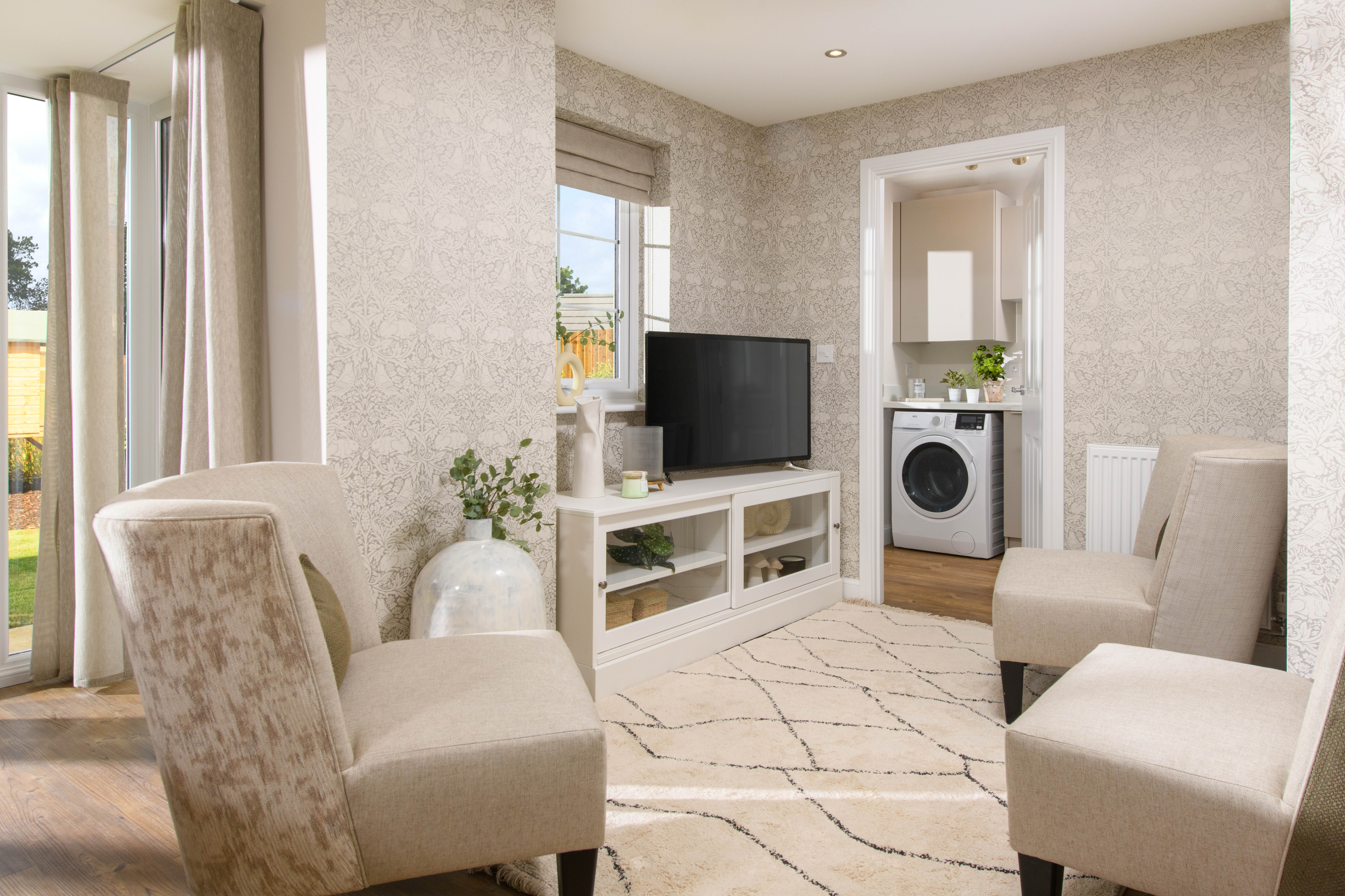 Open-plan kitchen with integrated appliances, dining area & family room with French doors leading onto garden & separate utility room