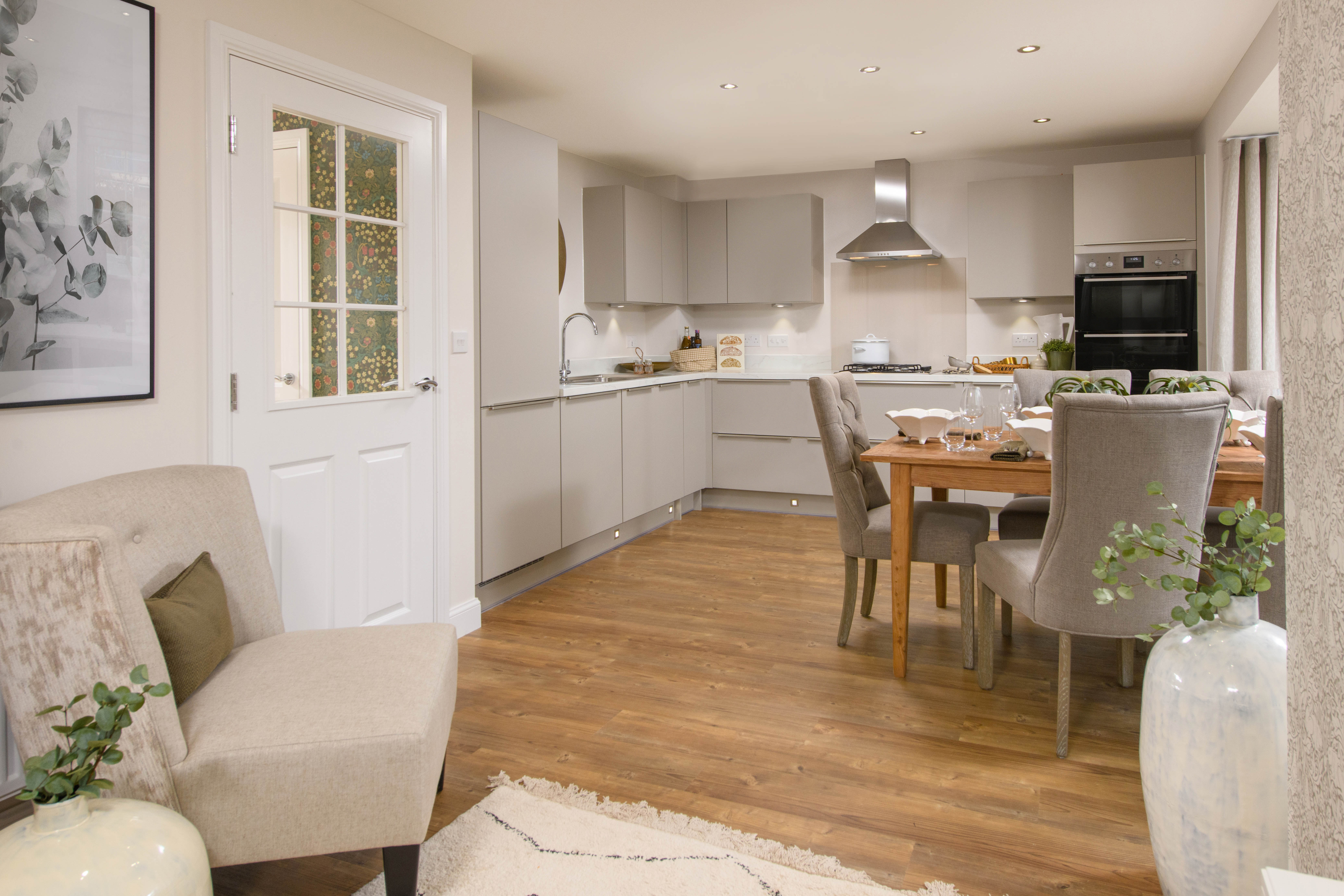Open-plan kitchen with integrated appliances, dining area & family room with French doors leading onto garden & separate utility room