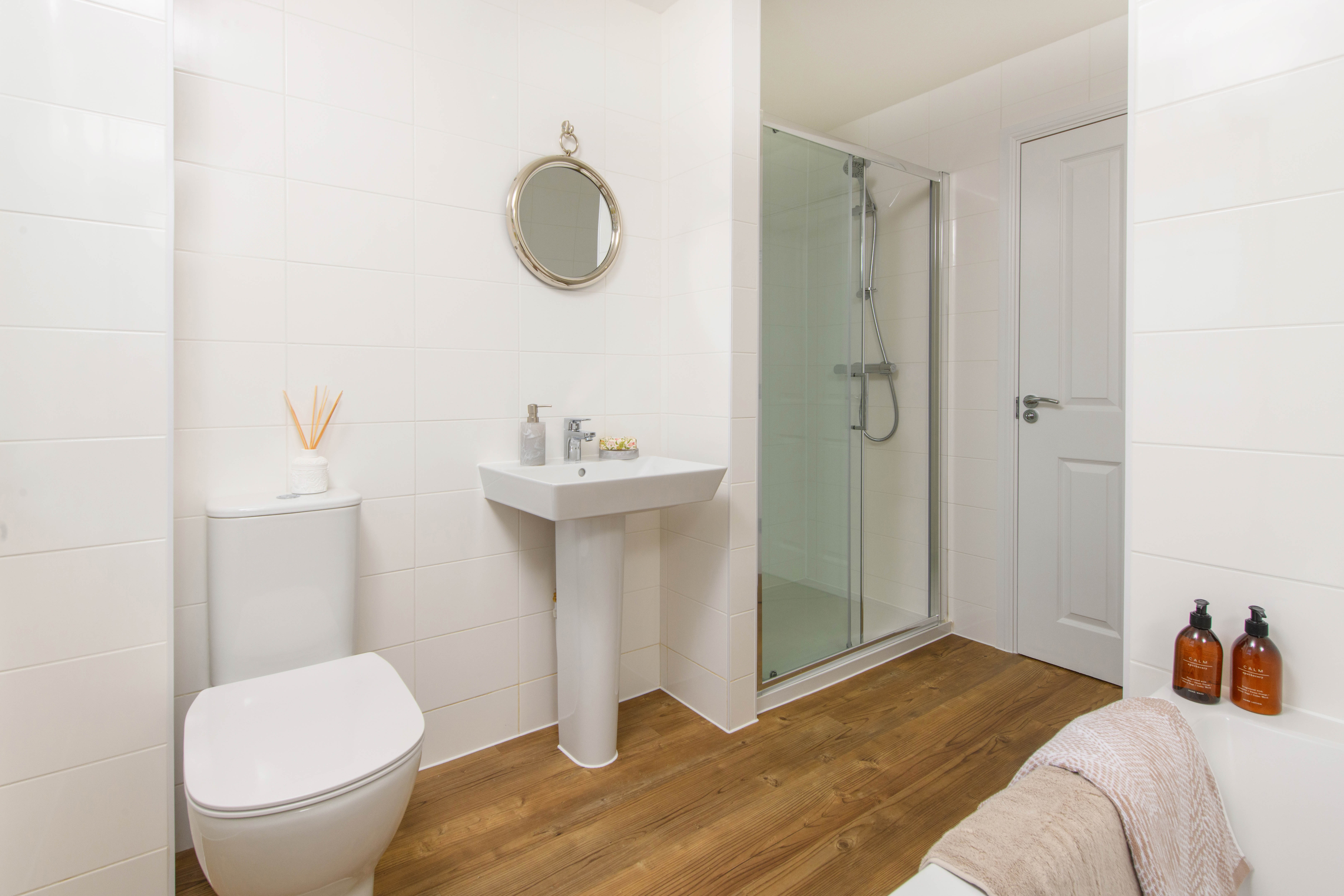 Family bathroom with shower over bath & storage