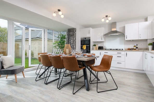Open-plan kitchen/dining area with glazed bay leading onto garden - Millford style home