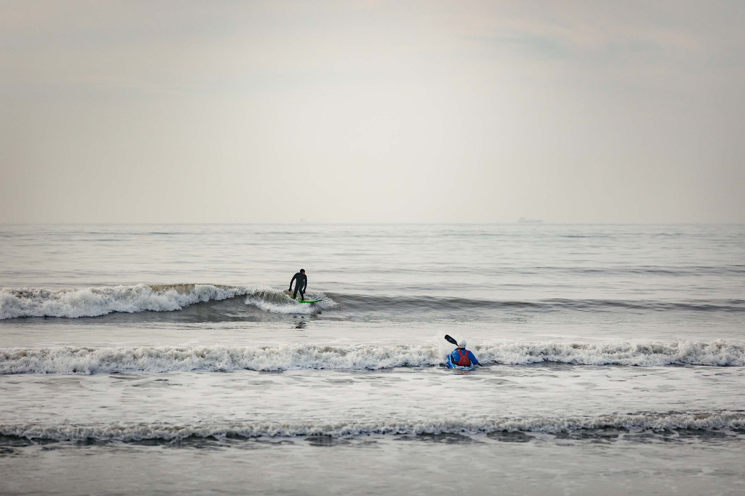 Local area shot of surfers at bracklesham bay/east-wittering beach