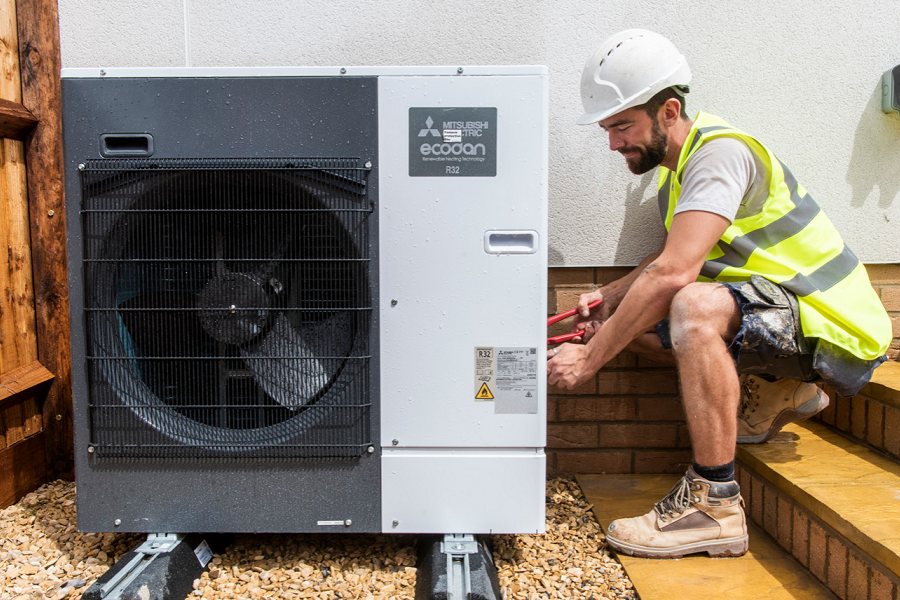 Man working on an air source heat pump