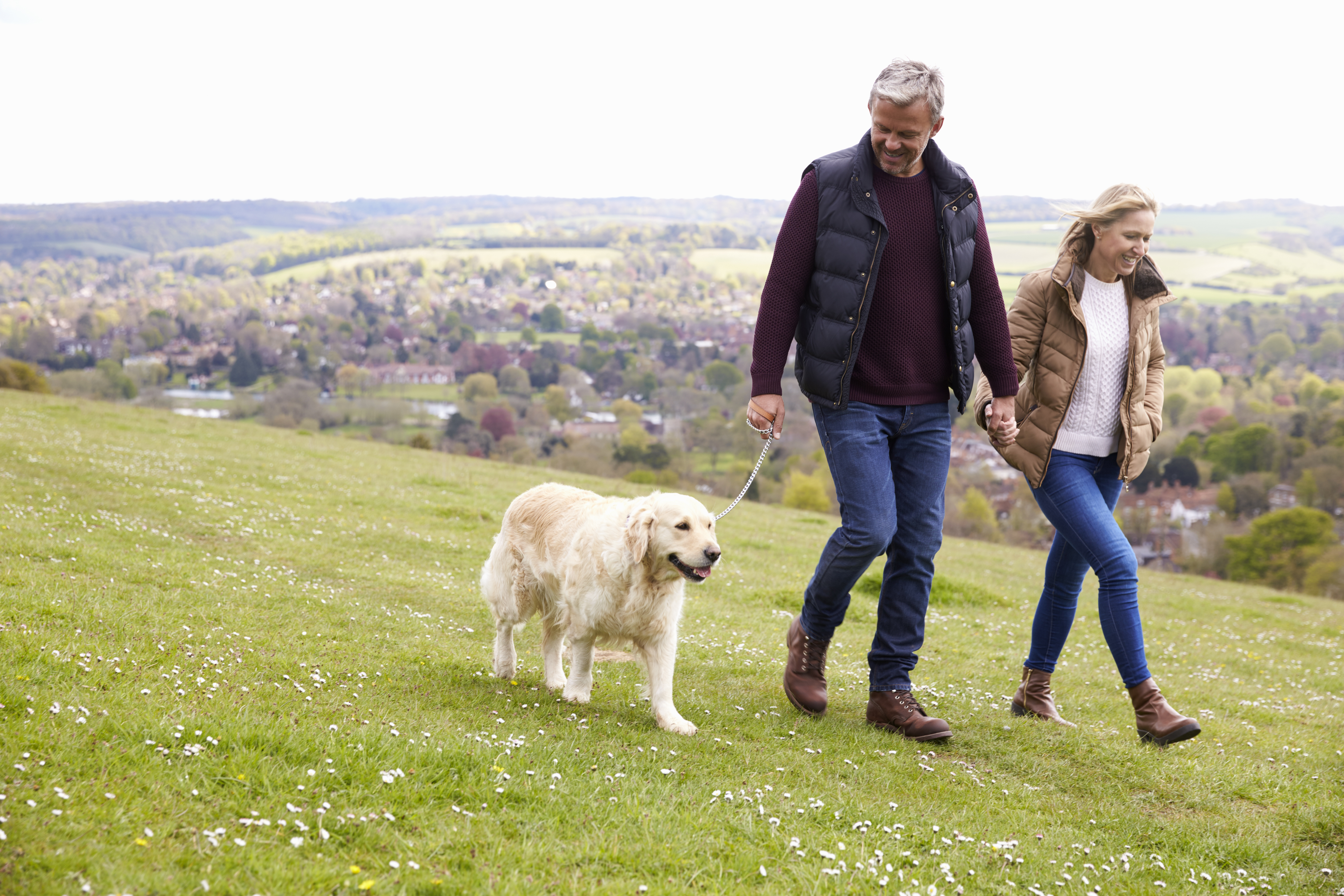 Couple walking their dog